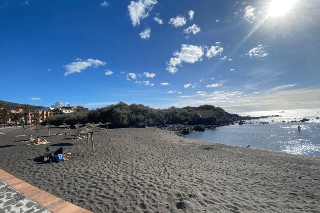 Kleiner Strand Charco Del Conde an einem sonnigen Tag mit Menschen, die sich an einem der besten Strände im Valle Gran Rey La Gomera auf den Kanarischen Inseln in Spanien sonnen